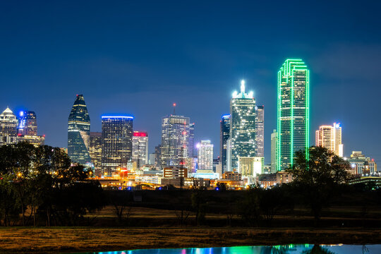 Downtown Dallas skyline at night from the Trinity River in Texas, USA.