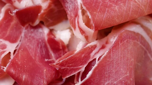 Spanish serrano ham rotating on wooden table