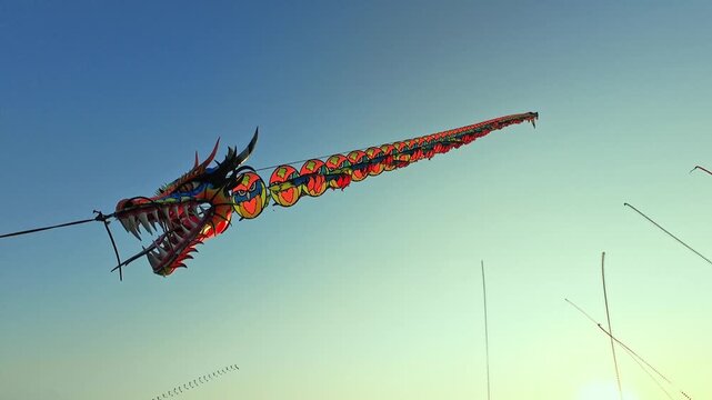 Colorful Long Indonesian Dragon Kite Flying In Blue Sky footage