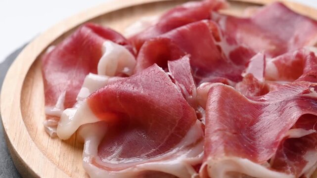 Spanish serrano ham rotating on wooden table