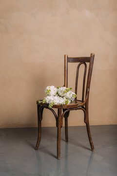 A bouquet of matthiola on an antique chair.
