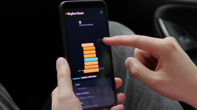 Player builds a growing tower in a smartphone stacking game, highlighting precision, timing, concentration and the rising appeal of quick skill-based mobile entertainment.