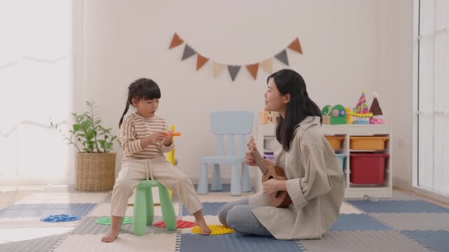 Mother Child Guitar Playroom Music Bonding Indoor Musical Joyful Family Moment with Toys, Plants, Colorful Bunting, Soft Natural Light, and Floor Mats for Creative Childhood Fun