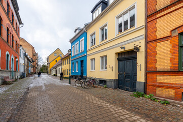 Fototapeta premium Charming row of colorful houses on a cobblestone street in winter. Malmo