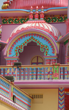 Vibrant traditional Hindu temple architecture details with colorful columns, patterned niches, and decorative relief ornament.