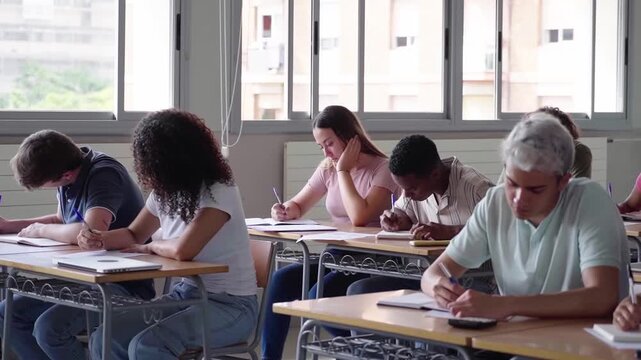 Diverse large group of students in a bright classroom studying. The scene highlights education, learning and collaboration. Copy space.
