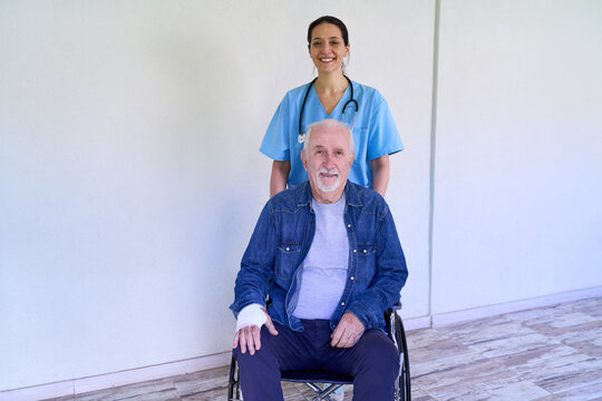 Home healthcare and senior care, nurse pushing elderly man in wheelchair with arm cast, recovery and wellness