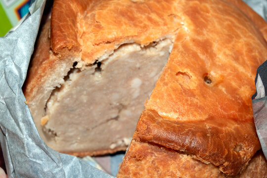 Close up of a freshly cut pork pie