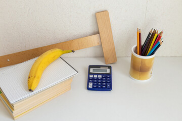 Back to school concept with books, colored pencils and banana © Sarolta Nagy