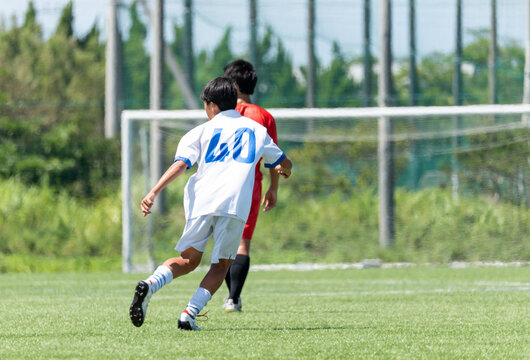 サッカーの試合をする中学生の男の子