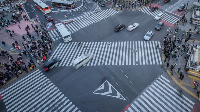 Shibuya crossing with people, timelapse aerial view in Tokyo, Japan, zooming out. 