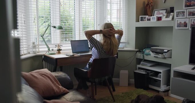 Woman, home office and laptop for remote work, relax and hands on head for thinking, back and working. Freelancer, deadline and online for job, technology and typing for problem solving and idea