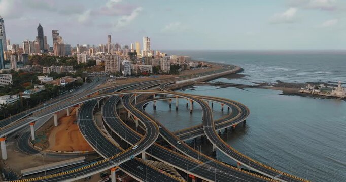 Morning view of the Mumbai Coastal Road in Maharashtra, India, famously known as the 'City of Dreams.' The scene captures a multi-level interchange roadway. A complex road network and urban designs.
