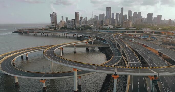 Morning view of the Mumbai Coastal Road in Maharashtra, India, famously known as the 'City of Dreams.' The scene captures a multi-level interchange roadway. A complex road network and urban designs.
