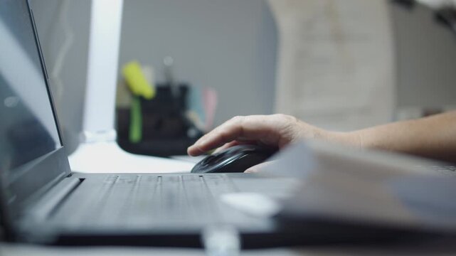 Hand Typing on Laptop Keyboard at Office Desk