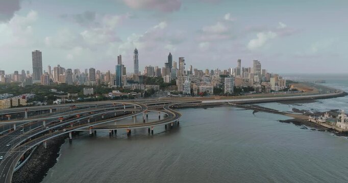 Morning view of the Mumbai Coastal Road in Maharashtra, India, famously known as the 'City of Dreams.' The scene captures a multi-level interchange roadway. A complex road network and urban designs.
