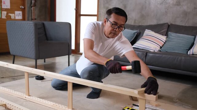 Furniture assembly carpenter wood home living room man building shelf table frame near sofa with hand tool