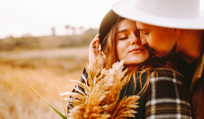 Portrait of a happy couple enjoying the sunset outdoors. A beautiful woman and man relax together...