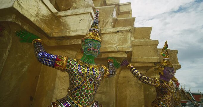 Giant guardians of Wat Phra Kaew are twelve massive statues of mythical demon warriors known as Yaksha sightseeing travel in Bangkok Thailand