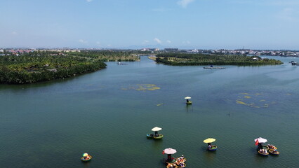 High angle view of traditional bamboo basket boats navigating the waterways of Cam Thanh coconut forest in Hoi An, Vietnam © GeoWild