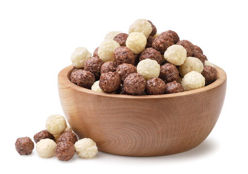 Sweet cereal balls in a wooden bowl on a white. Isolated