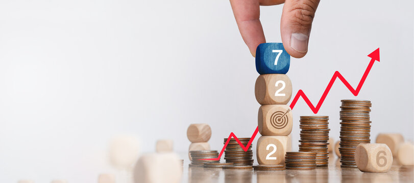 Financial Goals in 2027: Concepts of Financial Growth, Planning, Investment, and Tax. Wooden Blocks with 2027, Target Icon, and Coin Stacks.