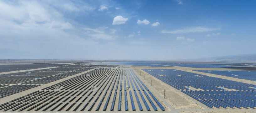 Aerial View of Expansive Solar Power Plant in Desert Under Blue Sky