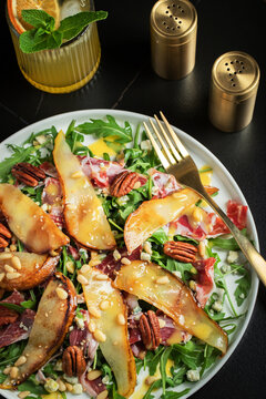 Salad with Pear, Arugula, Jamon, Blue Cheese and Blueberry, Delicious Fresh Salad Appetizer on Bright Background