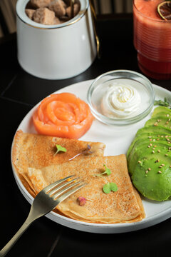 Roasted thin pancakes with smoked salmon and sauce