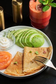 Roasted thin pancakes with smoked salmon and sauce