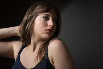 Fototapeta premium Beautiful Teenage Girl Posing for Beauty Portrait on Dark Background