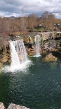 Vertical static wide shot of Pedrosa de la Tobalina waterfall and river pool in Burgos Spain