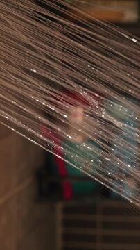 Bearded Person Rinses Bare Shoulder With a Shower in Tiled Bathroom, Water Spray Supports Daily Hygiene and Personal Care Vertical video.