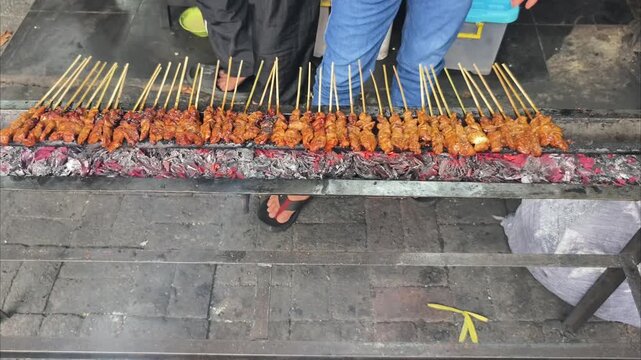 Grilling Chicken and Lamb Satay Skewers over Charcoal Fire Embers Indonesian Street Food Close Up