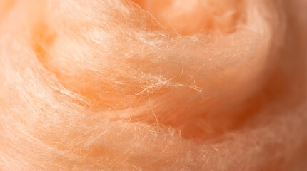 Fototapeta premium Soft orange cotton candy texture | Macro photography of peach wool fibers | Fluffy pastel orange abstract background | Delicate peach fibrous texture for design