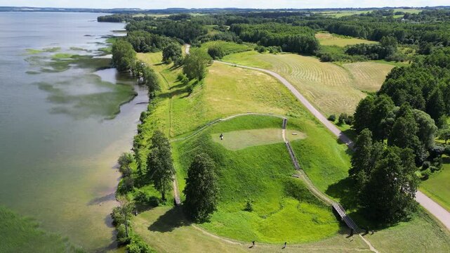 Crone view of Prelomciskes hillfort mound on a shore of Dusia Lake, Lithuania