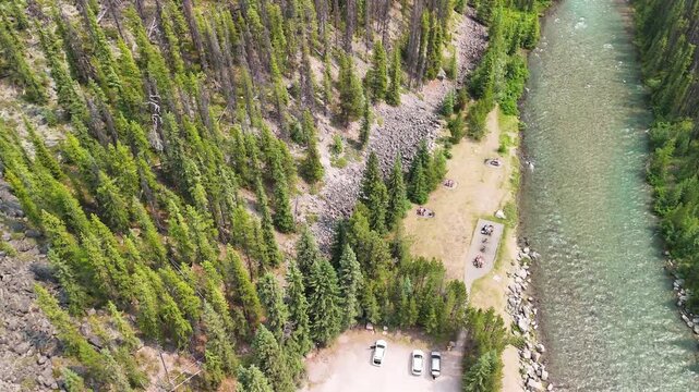 Wide aerial shot of Maligne River surrounded by pristine