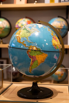 Global education and travel planning, world map globe with continents and oceans on a wooden shelf in a store