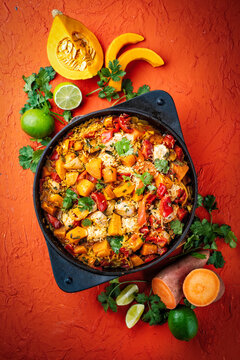 Slow cooked casserole dish  healthy yummy spicy Italian one-pan role stew vegetable pumpkin, sweet potato, chicken and rice served as top view