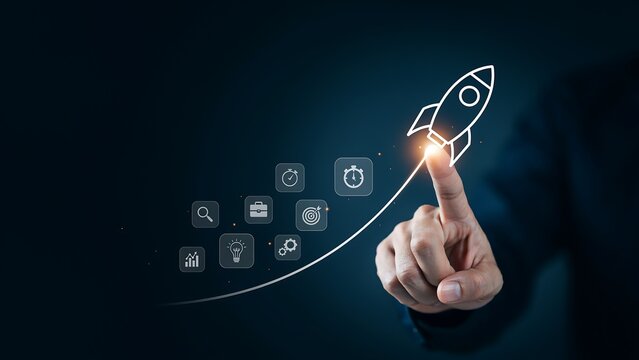 A hand presses a glowing button, launching a rocket graphic with a trail of business icons, symbolizing a new venture or product launch