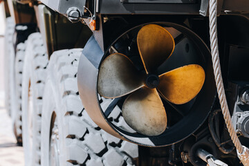 Close-up of ducted propeller and rugged tire on an amphibious military vehicle © Elninho