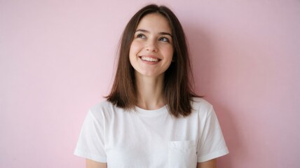 Fototapeta premium Dreamy Young Woman Smiling and Looking Up against Pink Background