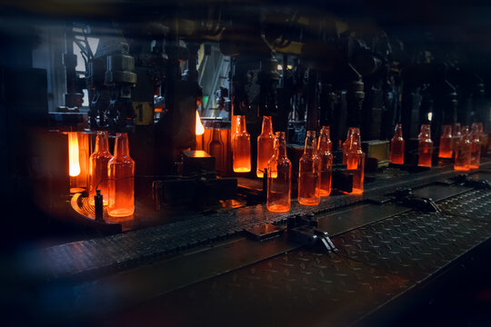 Automated Production of Glass Bottles in Manufacturing Plant. Motion blur is used for dynamics.
