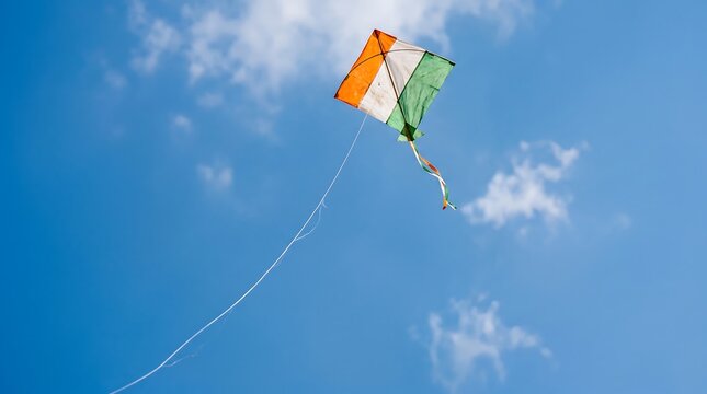 Indian tricolor kite flying high in the clear blue sky during Independence Day festival