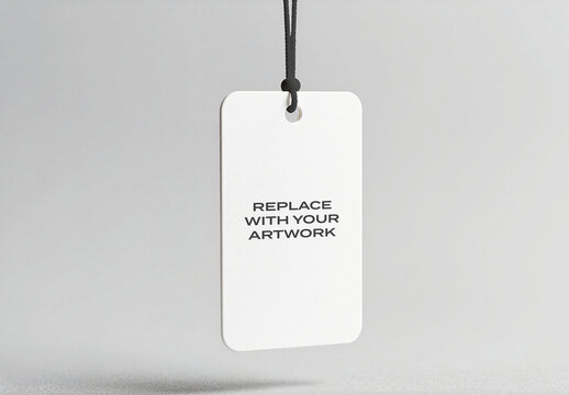 Rectangular product tag mockup hanging from black cord against neutral gray background, vertical presentation with placeholder text for branding artwork replacement, retail packaging display