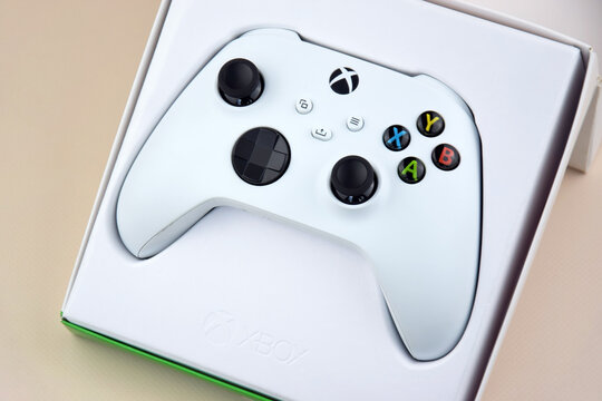 The white Xbox controller on the beige background.