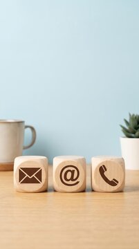 contact us icon email, address, phone, on wood cube, customer service and support for self quarantine business working at home, Telecommuting, Teleworking. 