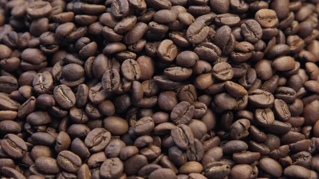 Coffee beans on display in a market during the morning hours for shoppers to see and choose, the grains rotate counterclockwise