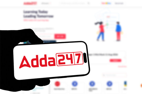 Kiel, Germany - 08-19-2026: Smartphone displaying Indian education technology company Adda247 logo in front of companys webpage