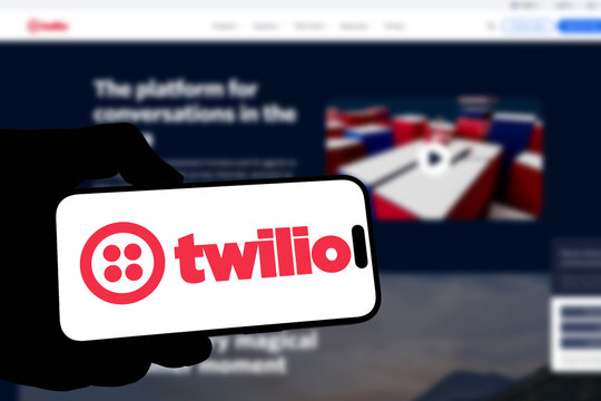 Kiel, Germany - 08-19-2026: Smartphone displaying US customer engagement software company Twilio logo in front of companys webpage